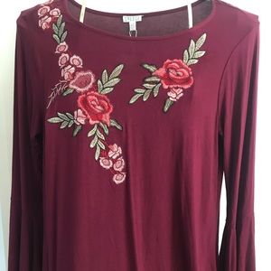 Burgundy (Pinot noir) dress with rose needle work and flared sleeves.